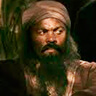 Ray Fearon en el papel de Abu Bakr